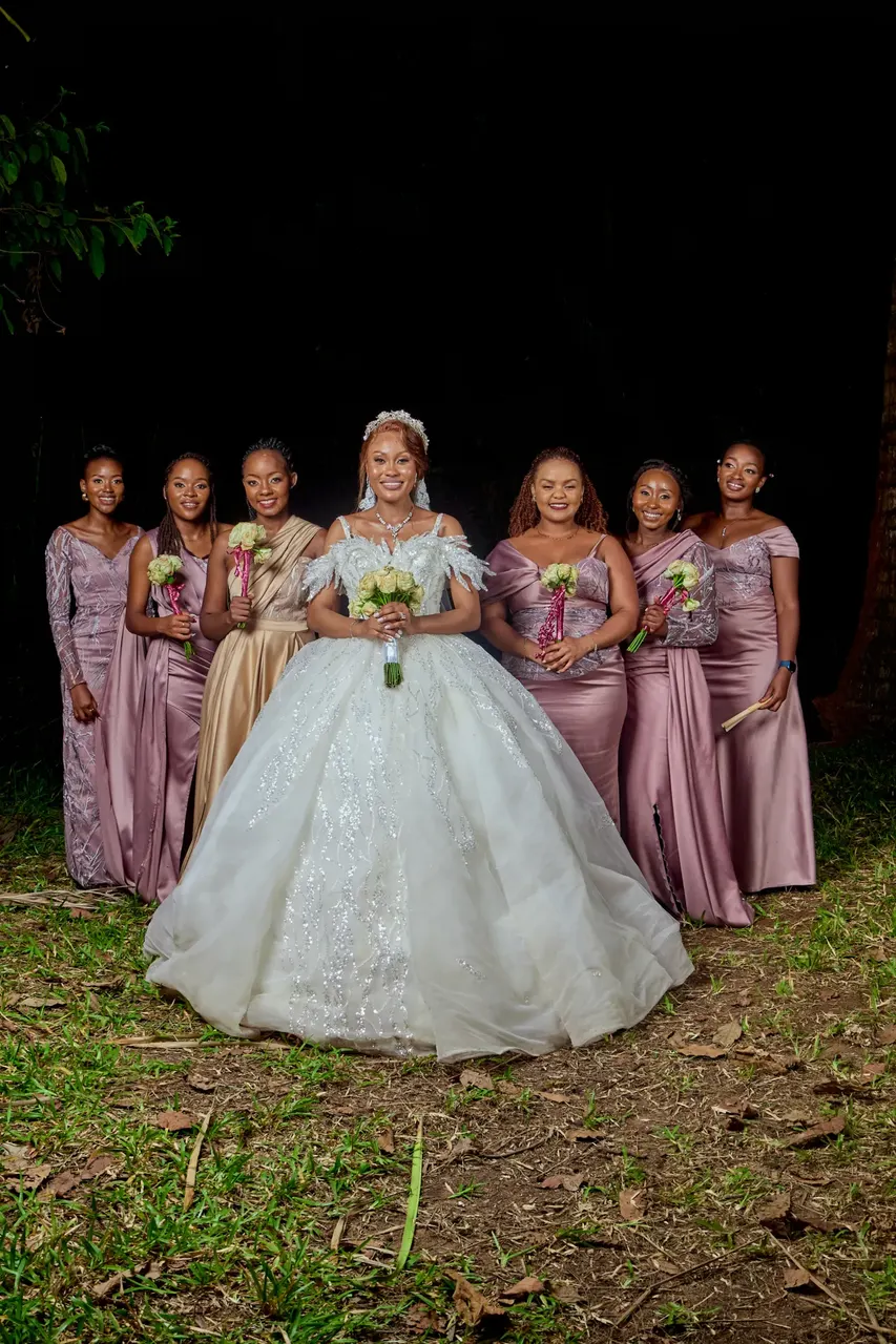 Bride and bridesmaids posing together at an evening wedding photoshoot