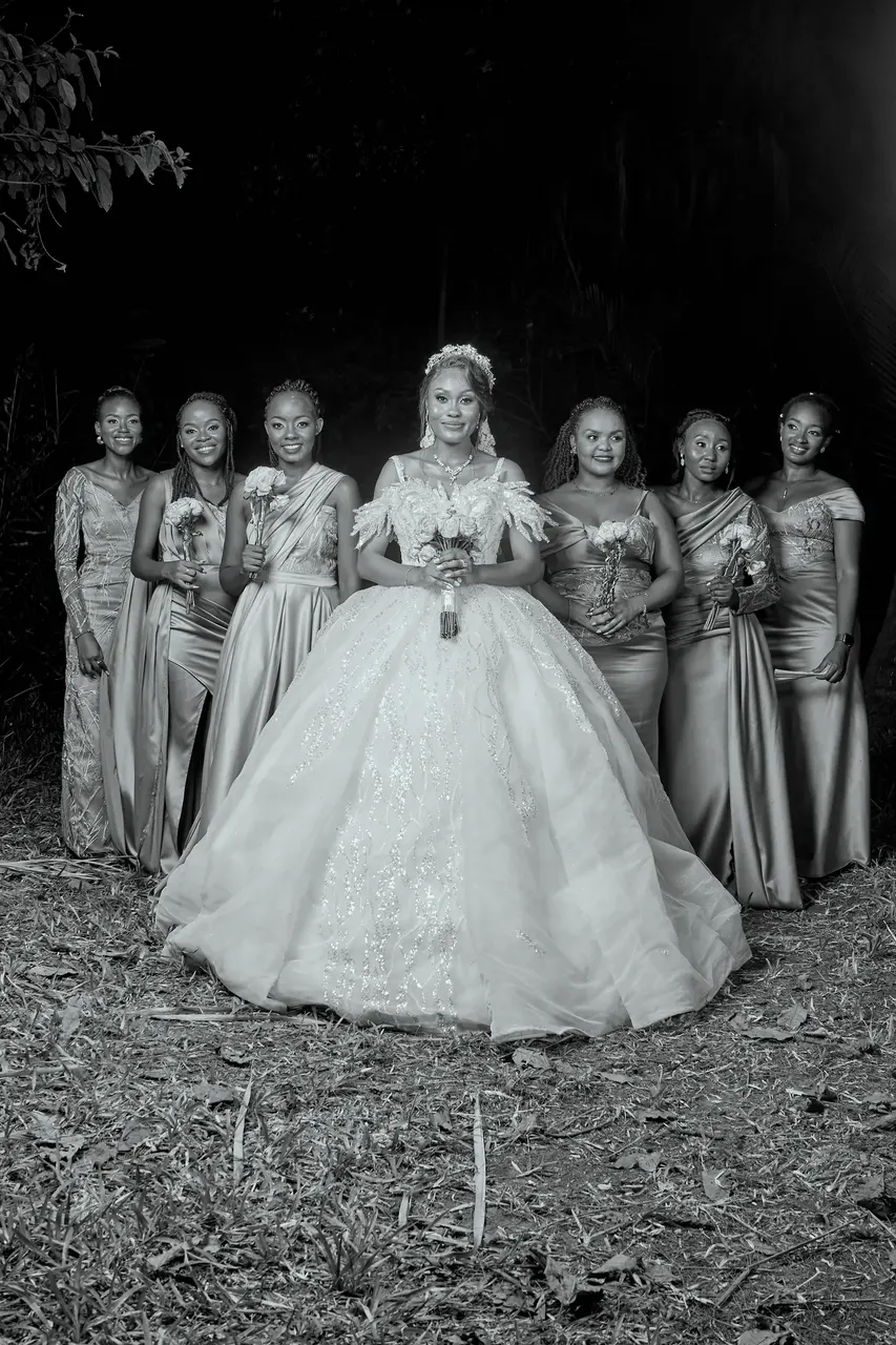 Black and white group photo of the bride surrounded by her bridesmaids